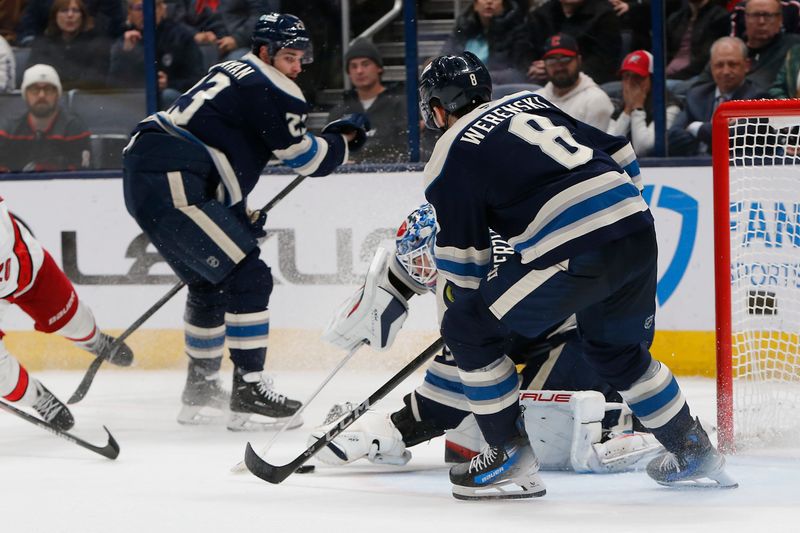 Dec 31, 2024; Columbus, Ohio, USA; Columbus Blue Jackets goalie Elvis Merzlikins (90) makes a save during overtime against the Carolina Hurricanes at Nationwide Arena. Mandatory Credit: Russell LaBounty-Imagn Images