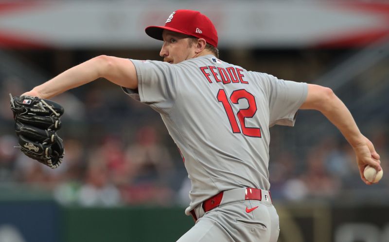 Jun 30, 2025; Pittsburgh, Pennsylvania, USA;  St. Louis Cardinals starting pitcher Erick Fedde (12) delivers a pitch against the Pittsburgh Pirates during the first inning at PNC Park. Mandatory Credit: Charles LeClaire-Imagn Images
