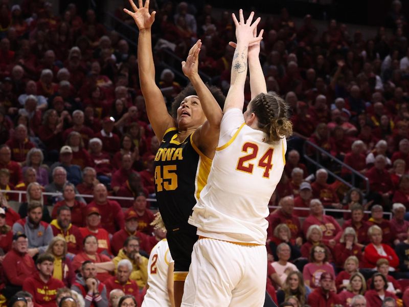Dec 10, 2025; Ames, Iowa, USA; Iowa Hawkeyes Hannah Stuelke (45) shoots over Iowa State Cyclones Addy Brown (24) during the second half at James H. Hilton Coliseum. Mandatory Credit: Reese Strickland-Imagn Images