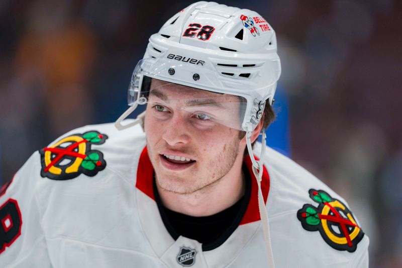 Mar 15, 2025; Vancouver, British Columbia, CAN; Chicago Blackhawks forward Colton Dach (28) smiles during warm up prior to a game against the Vancouver Canucks at Rogers Arena. Mandatory Credit: Bob Frid-Imagn Images