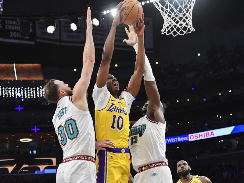 LOS ANGELES, CA - OCTOBER 22:  Christian Koloko #10 of the Los Angeles Lakers shoots the ball during the game against the Memphis Grizzlies on October 22, 2024 at Crypto.com Arena in Los Angeles, California. NOTE TO USER: User expressly acknowledges and agrees that, by downloading and/or using this Photograph, user is consenting to the terms and conditions of the Getty Images License Agreement. Mandatory Copyright Notice: Copyright 2024 NBAE (Photo by Juan Ocampo/NBAE via Getty Images)