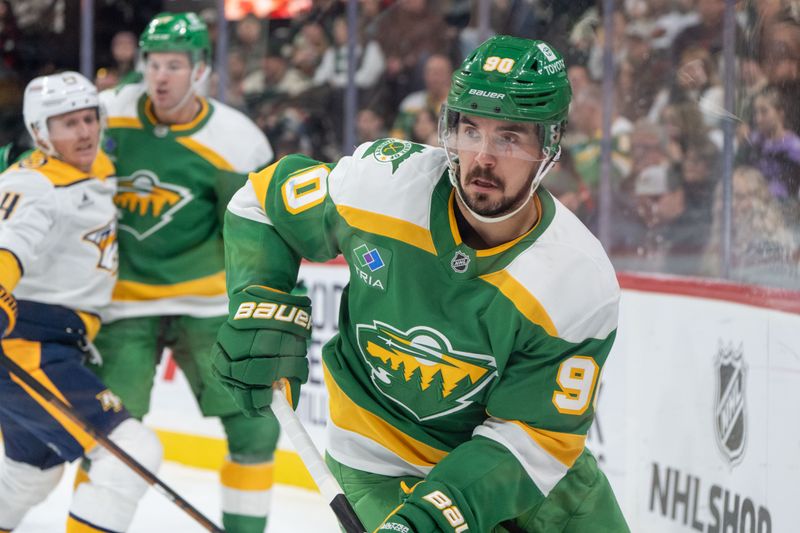 Dec 31, 2024; Saint Paul, Minnesota, USA; Minnesota Wild center Marcus Johansson (90) carries the puck around the boards agaisnt the Nashville Predators in the third period at Xcel Energy Center. Mandatory Credit: Matt Blewett-Imagn Images