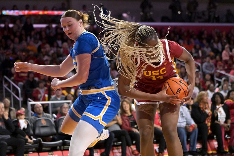 Jan 14, 2024; Los Angeles, California, USA; UCLA Bruins forward Lina Sontag (21) and USC Trojans center Clarice Akunwafo (34) go for a rebound in the first half at Galen Center. Mandatory Credit: Jayne Kamin-Oncea-USA TODAY Sports