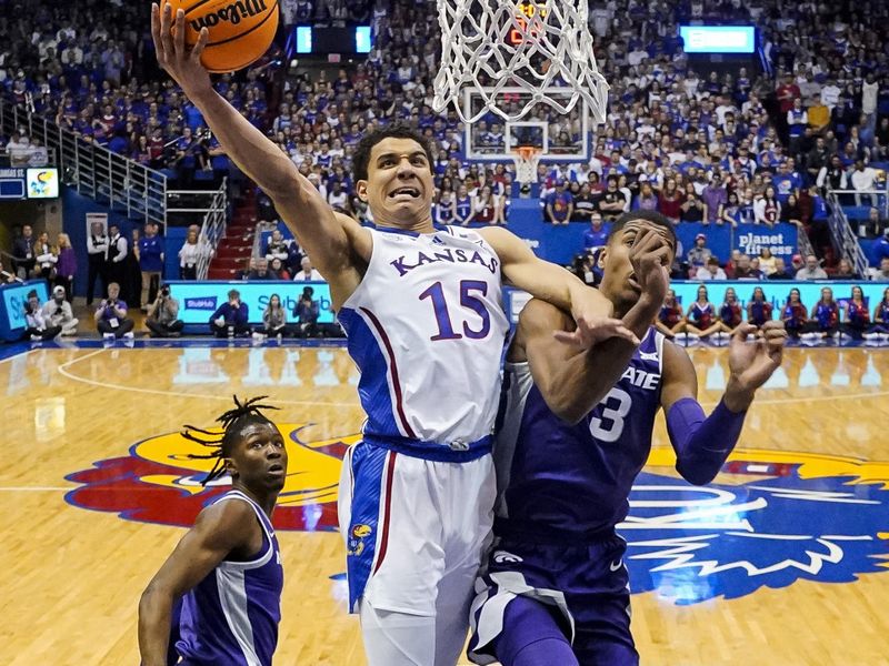 Jan 31, 2023; Lawrence, Kansas, USA; Kansas Jayhawks guard Kevin McCullar Jr. (15) shoots against Kansas State Wildcats forward David N'Guessan (3) and guard Markquis Nowell (1) during the second half at Allen Fieldhouse. Mandatory Credit: Jay Biggerstaff-USA TODAY Sports