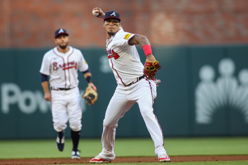 Apr 22, 2024; Atlanta, Georgia, USA; Miami Marlins shortstop Orlando Arcia (11) throws a runner out at home against the Atlanta Braves in the first inning at Truist Park. Mandatory Credit: Brett Davis-USA TODAY Sports