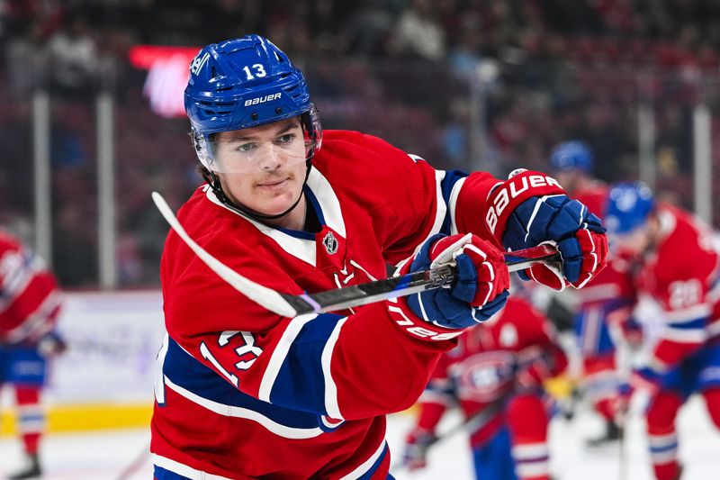 Nov 23, 2024; Montreal, Quebec, CAN; Montreal Canadiens right wing Cole Caufield (13) looks on during warm-up before the game against the Las Vegas Golden Knights at Bell Centre. Mandatory Credit: David Kirouac-Imagn Images