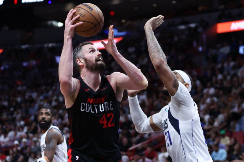 MIAMI, FLORIDA - APRIL 10: Kevin Love #42 of the Miami Heat drives against Daniel Gafford #21 of the Dallas Mavericks during the fourth quarter at Kaseya Center on April 10, 2024 in Miami, Florida. NOTE TO USER: User expressly acknowledges and agrees that, by downloading and or using this photograph, User is consenting to the terms and conditions of the Getty Images License Agreement. (Photo by Megan Briggs/Getty Images)