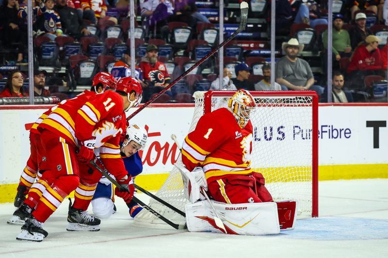 Sep 21, 2025; Calgary, Alberta, CAN; Calgary Flames goaltender Devin Cooley (1) makes a save against Edmonton Oilers center Connor Clattenburg (64) during the third period at Scotiabank Saddledome. Mandatory Credit: Sergei Belski-Imagn Images