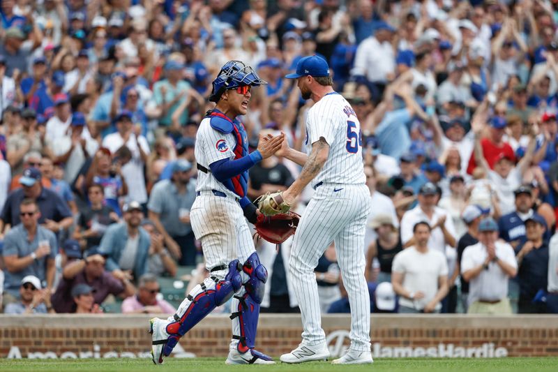 Jun 19, 2024; Chicago, Illinois, USA; Chicago Cubs relief pitcher Colten Brewer (54) celebrates with catcher Miguel Amaya (9) teams win against the San Francisco Giants at Wrigley Field. Mandatory Credit: Kamil Krzaczynski-USA TODAY Sports