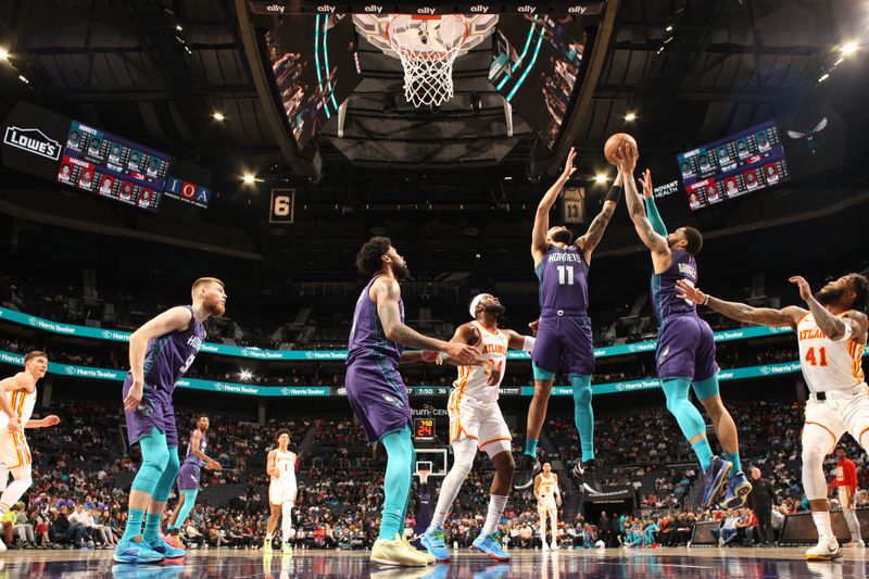 CHARLOTTE, NC - FEBRUARY 14: Miles Bridges #0 and Cody Martin #11 of the Charlotte Hornets rebound the ball during the game Atlanta Hawks on February 14, 2024 at Spectrum Center in Charlotte, North Carolina. NOTE TO USER: User expressly acknowledges and agrees that, by downloading and or using this photograph, User is consenting to the terms and conditions of the Getty Images License Agreement. Mandatory Copyright Notice: Copyright 2024 NBAE (Photo by Kent Smith/NBAE via Getty Images)