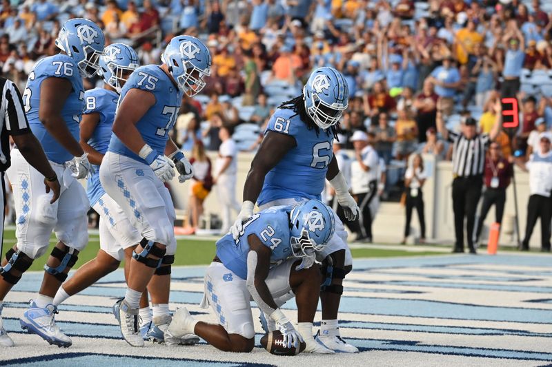 Sep 16, 2023; Chapel Hill, North Carolina, USA; North Carolina Tar Heels running back British Brooks (24) kneels in the end zone after scoring a touchdown in the fourth quarter at Kenan Memorial Stadium. Mandatory Credit: Bob Donnan-USA TODAY Sports