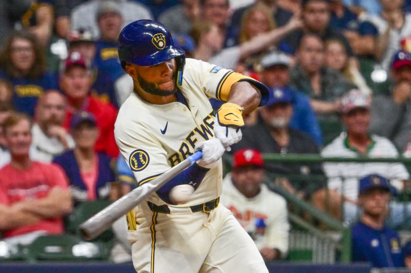 Sep 18, 2024; Milwaukee, Wisconsin, USA; Milwaukee Brewers left fielder Jackson Chourio (11) hits a triple in the ninth inning against the Philadelphia Phillies at American Family Field. Mandatory Credit: Benny Sieu-Imagn Images