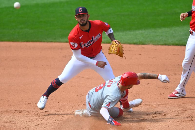 May 5, 2024; Cleveland, Ohio, USA; Cleveland Guardians shortstop Gabriel Arias (13) turns a double play beside Los Angeles Angels shortstop Zach Neto (9) in the fifth inning at Progressive Field. Mandatory Credit: David Richard-USA TODAY Sports
