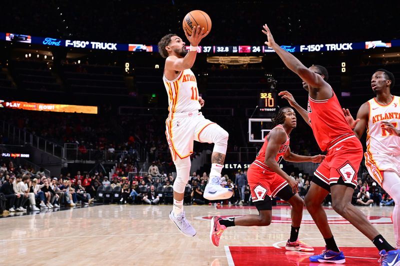 ATLANTA, GA - NOVEMBER 9: Trae Young #11 of the Atlanta Hawks drives to the basket during the game against the Chicago Bulls on November 9, 2024 at State Farm Arena in Atlanta, Georgia.  NOTE TO USER: User expressly acknowledges and agrees that, by downloading and/or using this Photograph, user is consenting to the terms and conditions of the Getty Images License Agreement. Mandatory Copyright Notice: Copyright 2024 NBAE (Photo by Adam Hagy/NBAE via Getty Images)