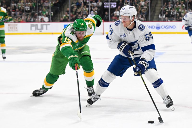 Mar 3, 2026; Saint Paul, Minnesota, USA;  Tampa Bay Lightning forward Jake Guentzel (59) protects the puck from Minnesota Wild forward Yakov Trenin (13) during the first period at Grand Casino Arena. Mandatory Credit: Nick Wosika-Imagn Images