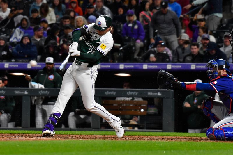 May 11, 2024; Denver, Colorado, USA; Colorado Rockies third base Ryan McMahon (24) singles against the Texas Rangers during the seventh inning at Coors Field. Mandatory Credit: John Leyba-USA TODAY Sports