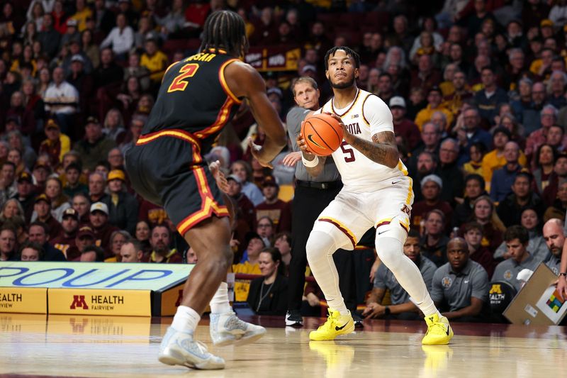 Jan 9, 2026; Minneapolis, Minnesota, USA; Minnesota Golden Gophers forward Jaylen Crocker-Johnson (5) shoots over Southern California Trojans forward Ezra Ausar (2) during the first half at Williams Arena. Mandatory Credit: Matt Krohn-Imagn Images