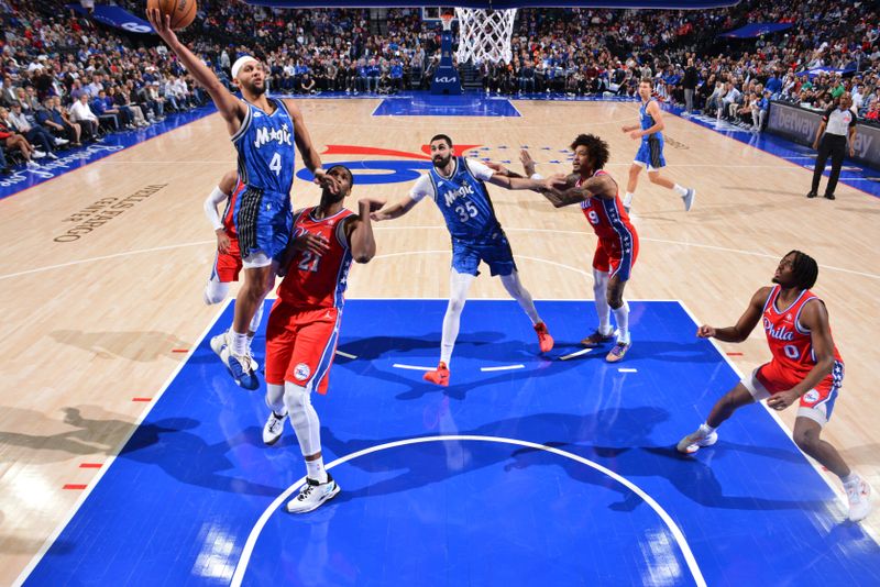 PHILADELPHIA, PA - APRIL 12: Jalen Suggs #4 of the Orlando Magic drives to the basket during the game against the Philadelphia 76ers on April 12, 2024 at the Wells Fargo Center in Philadelphia, Pennsylvania NOTE TO USER: User expressly acknowledges and agrees that, by downloading and/or using this Photograph, user is consenting to the terms and conditions of the Getty Images License Agreement. Mandatory Copyright Notice: Copyright 2024 NBAE (Photo by Jesse D. Garrabrant/NBAE via Getty Images)