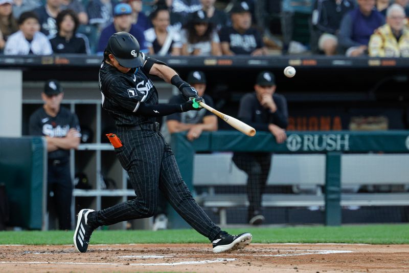 Aug 10, 2024; Chicago, Illinois, USA; Chicago White Sox second baseman Brooks Baldwin (27) hits an RBI-single against the Chicago Cubs during the second inning at Guaranteed Rate Field. Mandatory Credit: Kamil Krzaczynski-USA TODAY Sports