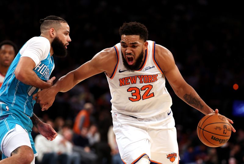 NEW YORK, NEW YORK - DECEMBER 05:  Karl-Anthony Towns #32 of the New York Knicks drives against Cody Martin #11 of the Charlotte Hornets during their game at Madison Square Garden on December 05, 2024 in New York City.  User expressly acknowledges and agrees that, by downloading and or using this photograph, User is consenting to the terms and conditions of the Getty Images License Agreement.  (Photo by Al Bello/Getty Images)