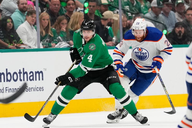 May 31, 2024; Dallas, Texas, USA; Dallas Stars defenseman Miro Heiskanen (4) skates with the puck ahead of Edmonton Oilers right wing Connor Brown (28) during the second period between the Dallas Stars and the Edmonton Oilers in game five of the Western Conference Final of the 2024 Stanley Cup Playoffs at American Airlines Center. Mandatory Credit: Chris Jones-USA TODAY Sports