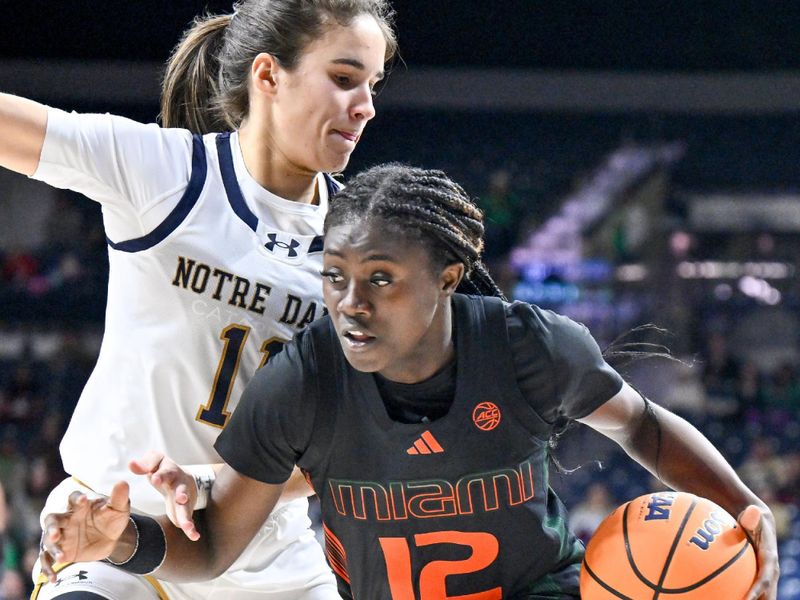 Jan 14, 2024; South Bend, Indiana, USA; Miami Hurricanes guard Ja'Leah Williams (12) drives to the basket as Notre Dame Fighting Irish guard Sonia Citron (11) defends in the second half at the Purcell Pavilion. Mandatory Credit: Matt Cashore-USA TODAY Sports