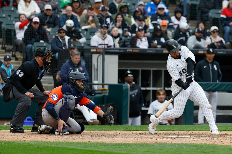 May 4, 2025; Chicago, Illinois, USA; Chicago White Sox second baseman Lenyn Sosa (50) hits a two-run single against the Houston Astros during the fifth inning at Rate Field. Mandatory Credit: Kamil Krzaczynski-Imagn Images