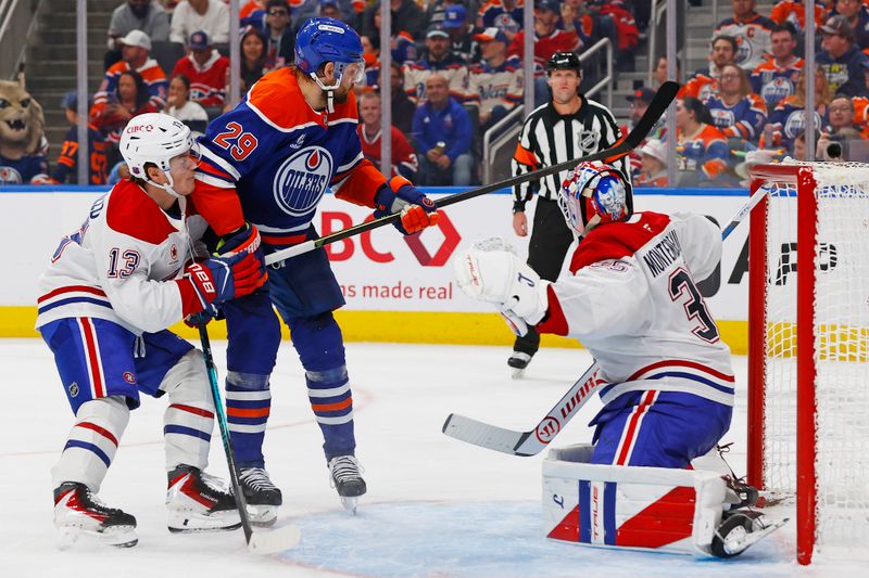 Oct 23, 2025; Edmonton, Alberta, CAN; Edmonton Oilers forward Leon Draisaitl (29) and Montreal Canadiens forward Cole Caufield (13) looks for a loose puck in front of goaltender Sam Montembeault (35) during the third period at Rogers Place. Mandatory Credit: Perry Nelson-Imagn Images