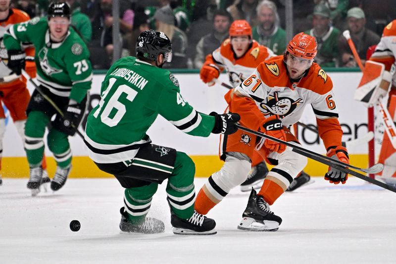 Nov 6, 2025; Dallas, Texas, USA; Dallas Stars defenseman Ilya Lyubushkin (46) and Anaheim Ducks left wing Cutter Gauthier (61) battle for control of the puck during the first period at the American Airlines Center. Mandatory Credit: Jerome Miron-Imagn Images