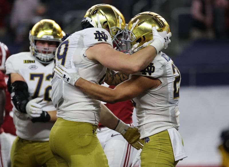 Jan 1, 2021; Arlington, TX, USA; Notre Dame Fighting Irish running back Kyren Williams (23) celebrates with Notre Dame Fighting Irish offensive lineman Aaron Banks (69) his touchdown scored against the Alabama Crimson Tide during the first half in the Rose Bowl at AT&T Stadium. Mandatory Credit: Kevin Jairaj-USA TODAY Sports