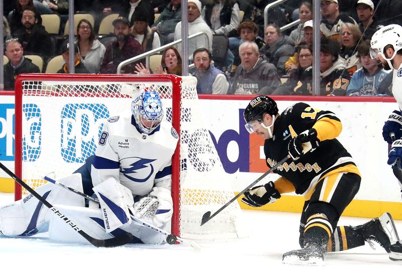 Nov 19, 2024; Pittsburgh, Pennsylvania, USA; Tampa Bay Lightning goaltender Andrei Vasilevskiy (88) makes a save against Pittsburgh Penguins right wing Bryan Rust (17) during the third period at PPG Paints Arena. Mandatory Credit: Charles LeClaire-Imagn Images