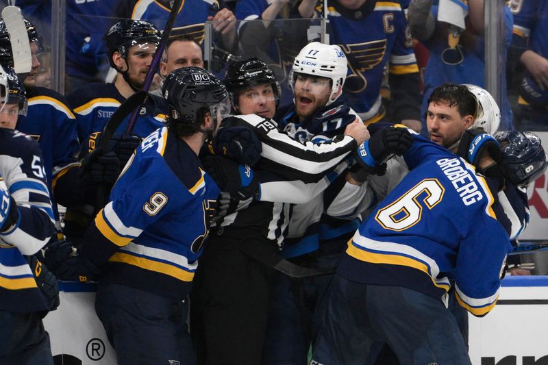 Apr 27, 2025; St. Louis, Missouri, USA; Winnipeg Jets center Adam Lowry (17) battles with St. Louis Blues left wing Alexandre Texier (9) during the third period in game four of the first round of the 2025 Stanley Cup Playoffs at Enterprise Center. Mandatory Credit: Jeff Le-Imagn Images