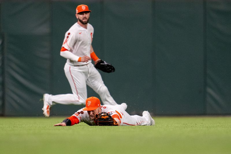 Aug 29, 2023; San Francisco, California, USA;  San Francisco Giants center fielder Austin Slater (13) makes a diving catch during the eighth inning against the Cincinnati Reds at Oracle Park. Mandatory Credit: Neville E. Guard-USA TODAY Sports