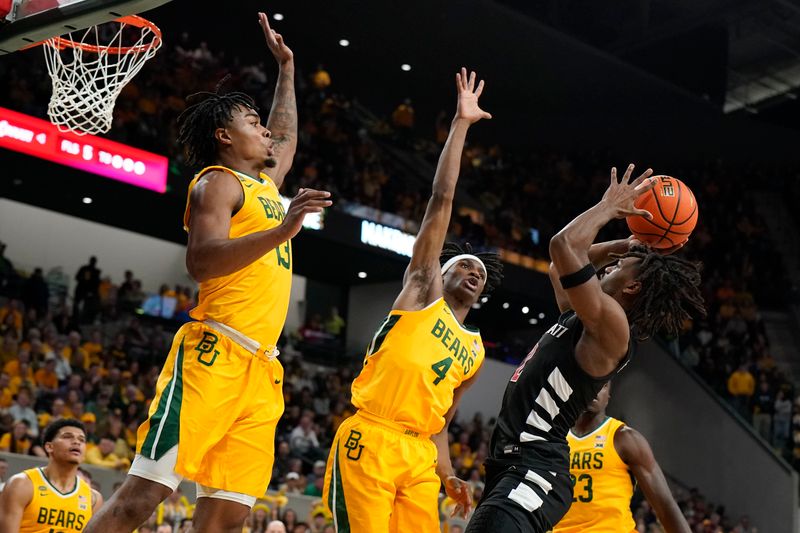 Jan 13, 2024; Waco, Texas, USA; Baylor Bears guard Langston Love (13) and guard Ja'Kobe Walter (4) defend Cincinnati Bearcats guard Jizzle James (2) during the first half at Paul and Alejandra Foster Pavilion. Mandatory Credit: Raymond Carlin III-USA TODAY Sports