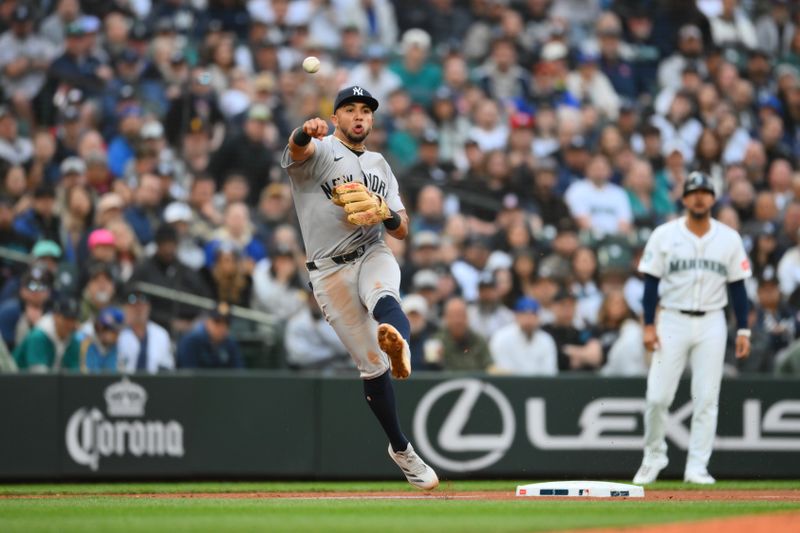 May 13, 2025; Seattle, Washington, USA; New York Yankees third baseman Oswald Peraza (18) throws to first base for a force out on Seattle Mariners third baseman Ben Williamson (9) (not pictured) during the third inning at T-Mobile Park. Mandatory Credit: Steven Bisig-Imagn Images