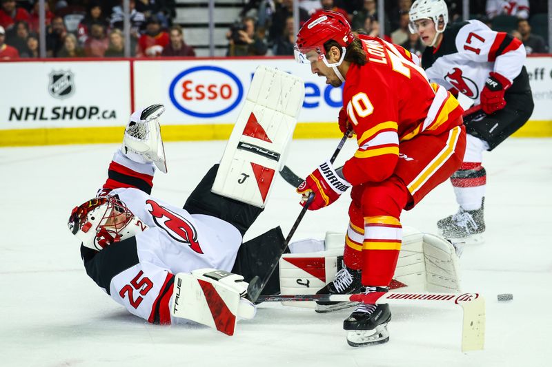 Jan 19, 2026; Calgary, Alberta, CAN; New Jersey Devils goaltender Jacob Markstrom (25) makes a save against Calgary Flames left wing Ryan Lomberg (70) during the second period at Scotiabank Saddledome. Mandatory Credit: Sergei Belski-Imagn Images