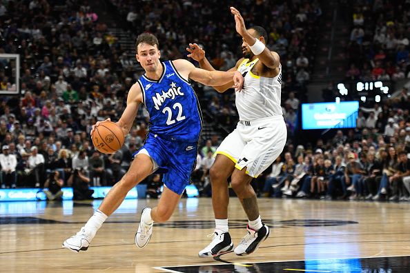 SALT LAKE CITY, UTAH - NOVEMBER 02: Franz Wagner #22 of the Orlando Magic drives into Talen Horton-Tucker #5 of the Utah Jazz during the second half of a game at Delta Center on November 02, 2023 in Salt Lake City, Utah. NOTE TO USER: User expressly acknowledges and agrees that, by downloading and or using this photograph, User is consenting to the terms and conditions of the Getty Images License Agreement.  (Photo by Alex Goodlett/Getty Images)