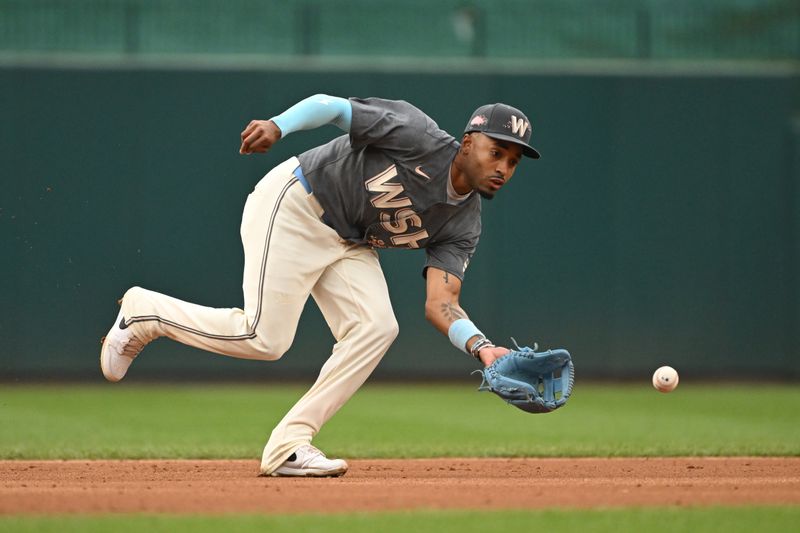 Sep 29, 2024; Washington, District of Columbia, USA; Washington Nationals shortstop Nasim Nunez (26) fields a ground ball against the Philadelphia Phillies during the third inning at Nationals Park. Mandatory Credit: Rafael Suanes-Imagn Images