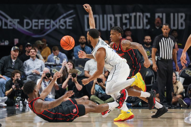 Jan 25, 2023; Orlando, Florida, USA; UCF Knights guard Darius Johnson (3) and Houston Cougars guard Jamal Shead (1) chase a loose ball during the second half at Addition Financial Arena. Mandatory Credit: Mike Watters-USA TODAY Sports