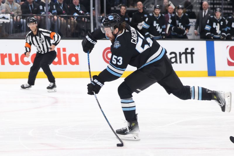 Jan 29, 2025; Salt Lake City, Utah, USA; Utah Hockey Club left wing Michael Carcone (53) shoots and scores against the Pittsburgh Penguins during the second period at Delta Center. Mandatory Credit: Rob Gray-Imagn Images