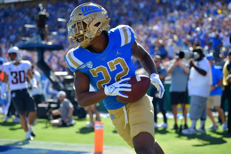 Oct 7, 2023; Pasadena, California, USA; UCLA Bruins wide receiver Keegan Jones (22) celebrates his touchdown scored against the Washington State Cougars during the second half at Rose Bowl. Mandatory Credit: Gary A. Vasquez-USA TODAY Sports