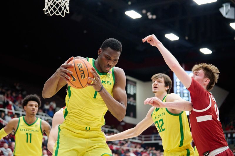 Jan 21, 2023; Stanford, California, USA; Oregon Ducks center N'Faly Dante (1) secures a defensive rebound against Stanford Cardinal forward Max Murrell (10) during the first half at Maples Pavilion. Mandatory Credit: Robert Edwards-USA TODAY Sports