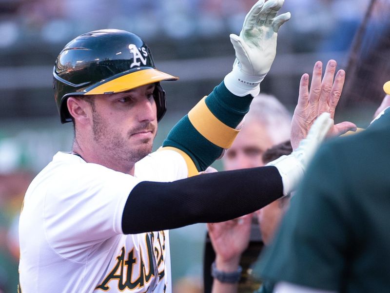 Jul 2, 2024; Oakland, California, USA; Oakland Athletics outfielder Brent Rooker (25) high fives team mates after hitting a home run against the Los Angeles Angels during the fourth inning at Oakland-Alameda County Coliseum. Mandatory Credit: Ed Szczepanski-USA TODAY Sports