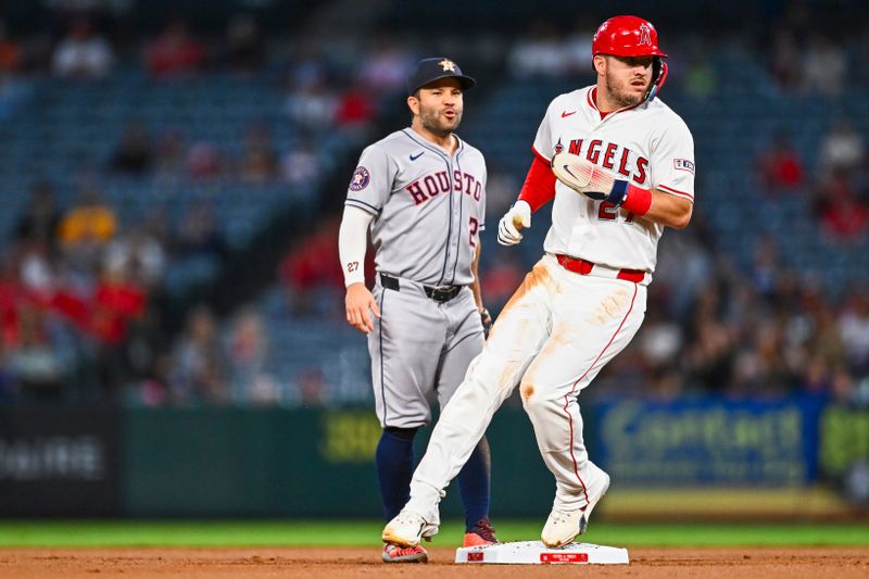 Sep 27, 2025; Anaheim, California, USA; Los Angeles Angels designated hitter Mike Trout (27) runs to second base against Houston Astros second baseman Jose Altuve (27) during the first inning at Angel Stadium. Mandatory Credit: Jonathan Hui-Imagn Images