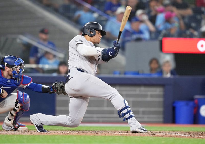 Jun 30, 2024; Toronto, Ontario, CAN; New York Yankees right fielder Juan Soto (22) grounds out against the Toronto Blue Jays during the eighth inning at Rogers Centre. Mandatory Credit: Nick Turchiaro-USA TODAY Sports