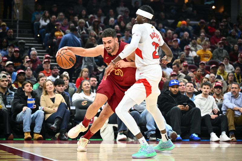 CLEVELAND, OHIO - JANUARY 09: Georges Niang #20 of the Cleveland Cavaliers drives to the basket around Chris Boucher #25 of the Toronto Raptors during the first quarter at Rocket Mortgage Fieldhouse on January 09, 2025 in Cleveland, Ohio. NOTE TO USER: User expressly acknowledges and agrees that, by downloading and or using this photograph, User is consenting to the terms and conditions of the Getty Images License Agreement. (Photo by Jason Miller/Getty Images)