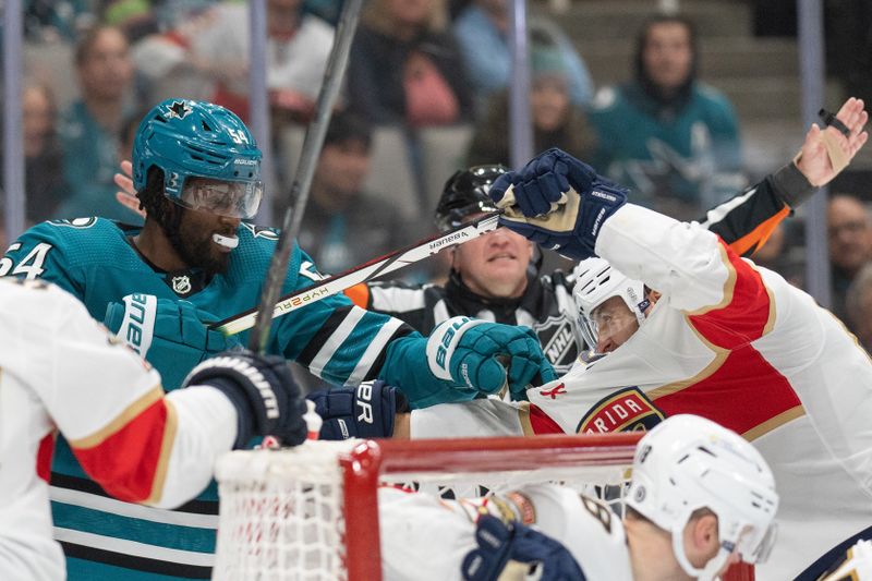 Nov 14, 2023; San Jose, California, USA; San Jose Sharks right wing Givani Smith (54) and Florida Panthers center Kevin Stenlund (82) fight during the second period at SAP Center at San Jose. Mandatory Credit: Stan Szeto-USA TODAY Sports