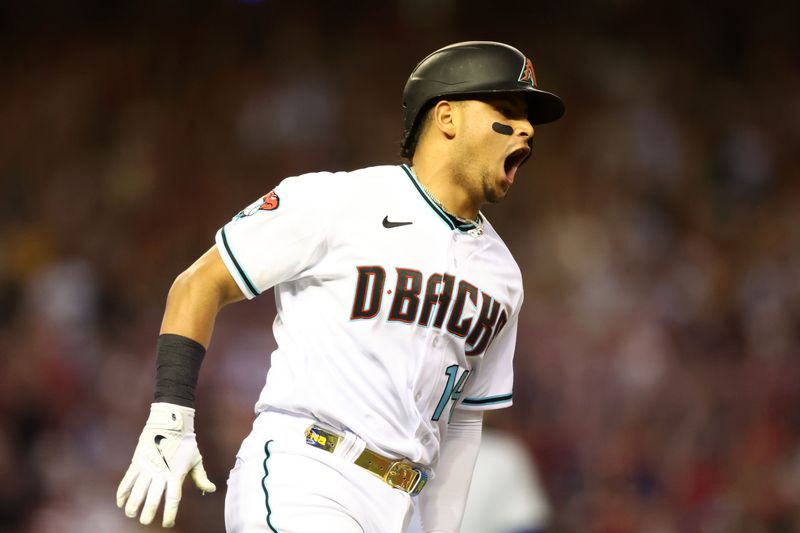 Oct 11, 2023; Phoenix, Arizona, USA; Arizona Diamondbacks catcher Gabriel Moreno (14) reacts after hitting a home run against the Los Angeles Dodgers in the third inning for game three of the NLDS for the 2023 MLB playoffs at Chase Field. Mandatory Credit: Mark J. Rebilas-USA TODAY Sports