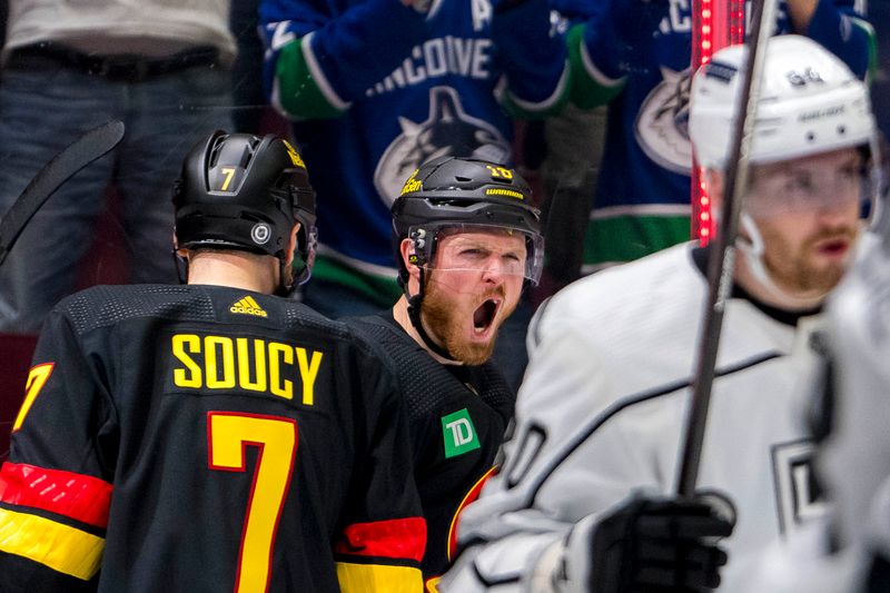 Mar 25, 2024; Vancouver, British Columbia, CAN; Vancouver Canucks defenseman Carson Soucy (7) and forward Sam Lafferty (18) celebrate Lafferty’s goal against the Los Angeles Kings in the first period at Rogers Arena. Mandatory Credit: Bob Frid-USA TODAY Sports