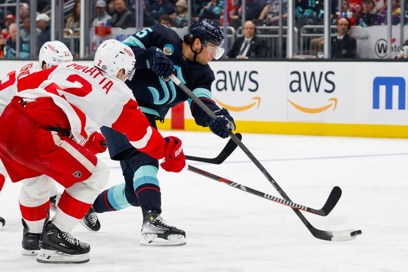 Feb 19, 2024; Seattle, Washington, USA; Seattle Kraken left wing Andre Burakovsky (95) shoots the puck against the Detroit Red Wings during the second period at Climate Pledge Arena. Mandatory Credit: Joe Nicholson-USA TODAY Sports